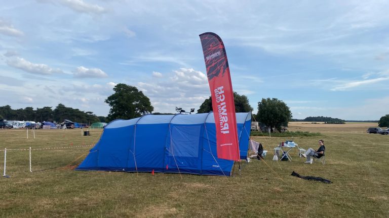 The club flag flying high over the campsite