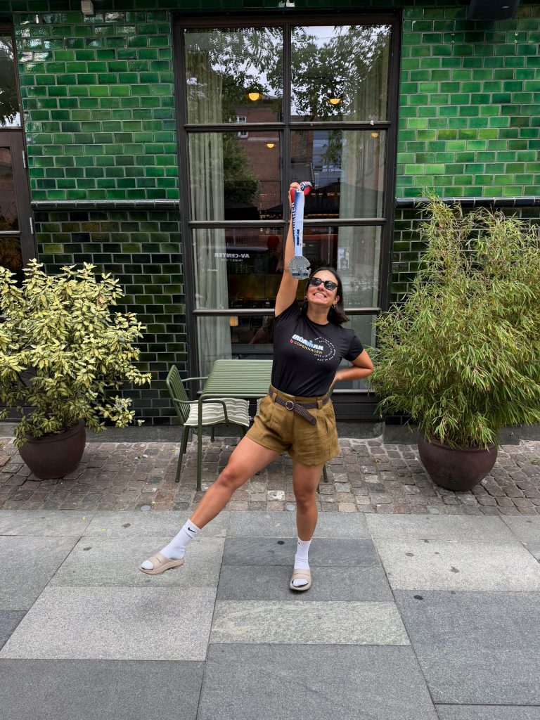 Tara showing off her medal and event tee