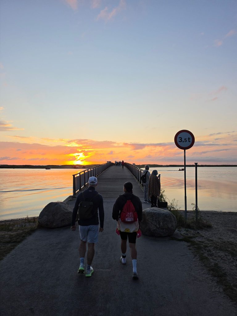Tara and Daren walking to the swim start while the sun rises